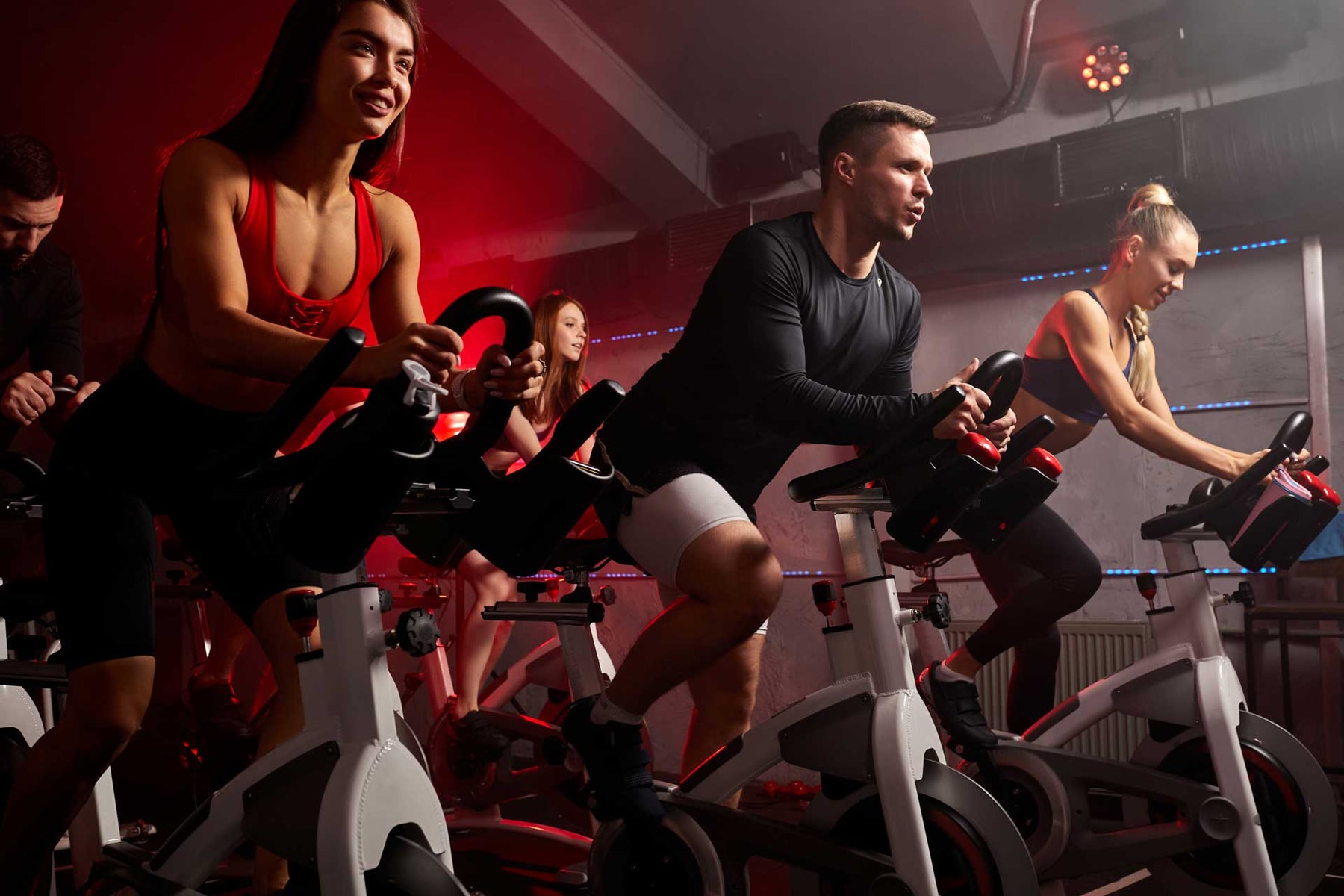people biking in spinning class at modern gym