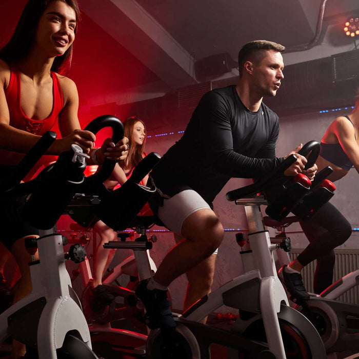 people biking in spinning class at modern gym